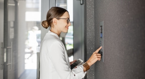 woman at building door with keypad