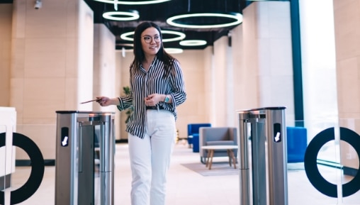 person going through commercial turnstiles